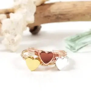 Stacking heart rings in yellow gold, silver, and rose gold