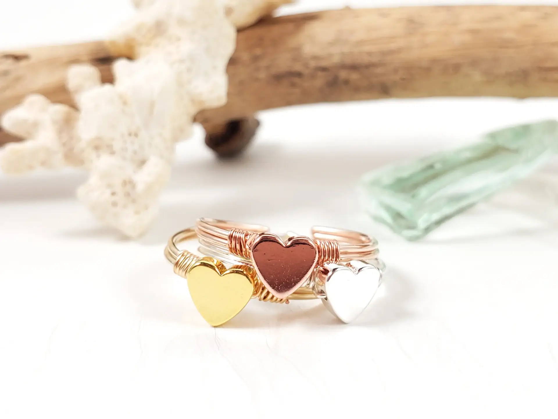 Stacking heart rings in yellow gold, silver, and rose gold