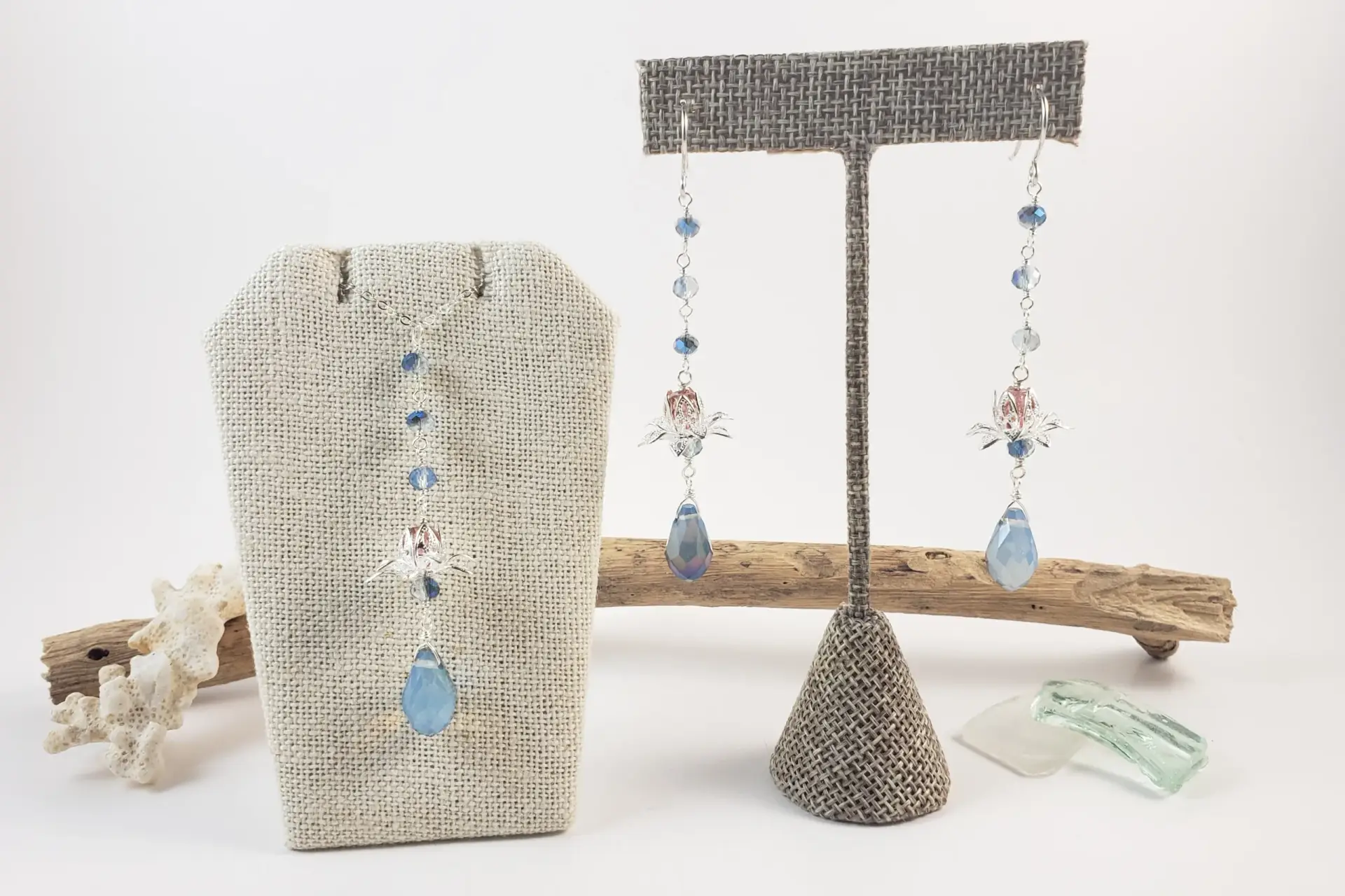 Silver lotus and blue crystal earrings and necklace