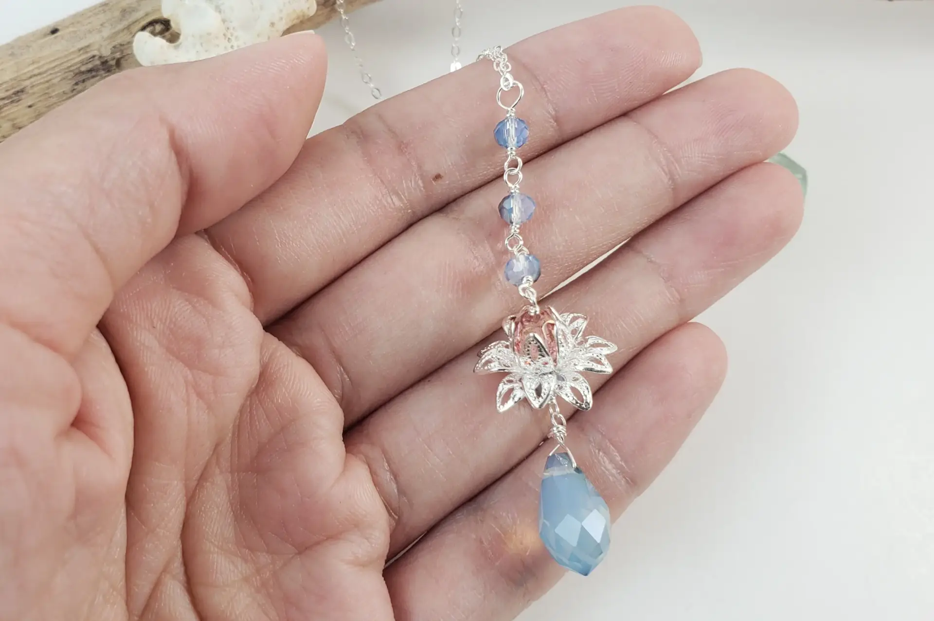 Silver lotus and blue crystal earrings and necklace - Image 2