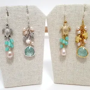 Turtles, pearls, and glass asymmetrical earrings and necklaces in silver and gold